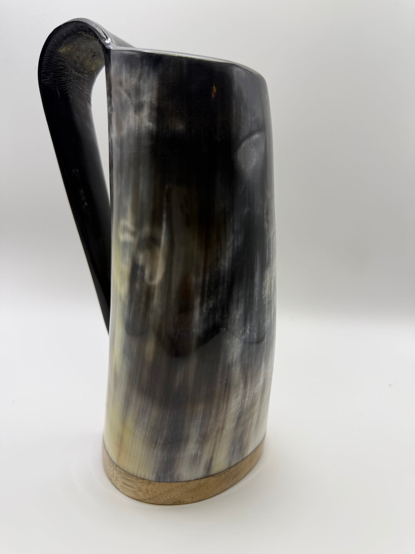 Horn-shaped mug with a handle on a white background