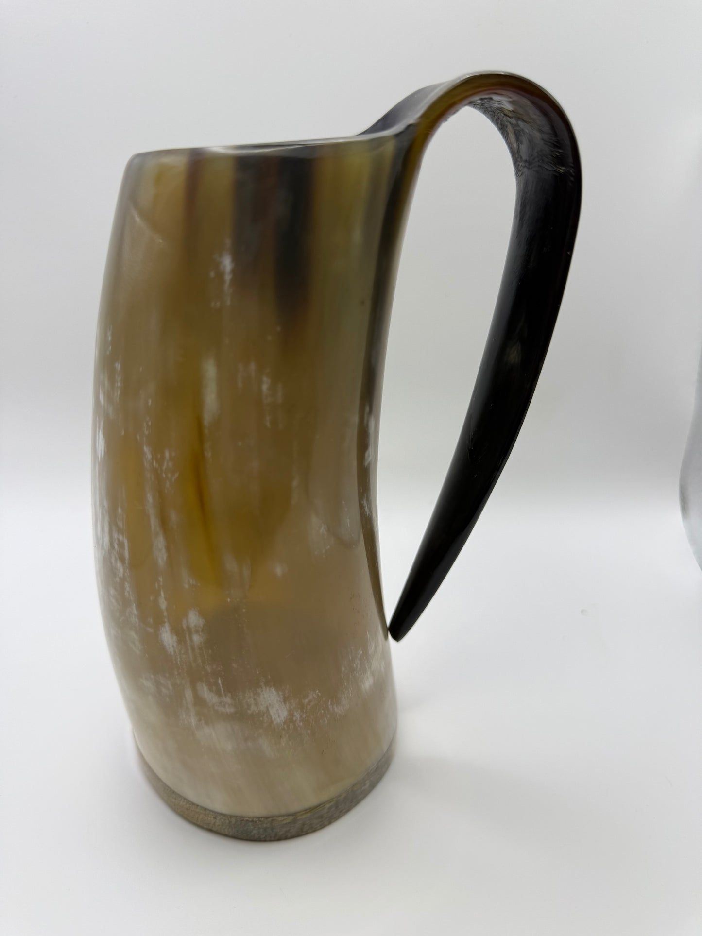 Horn-shaped mug with a black handle on a white background