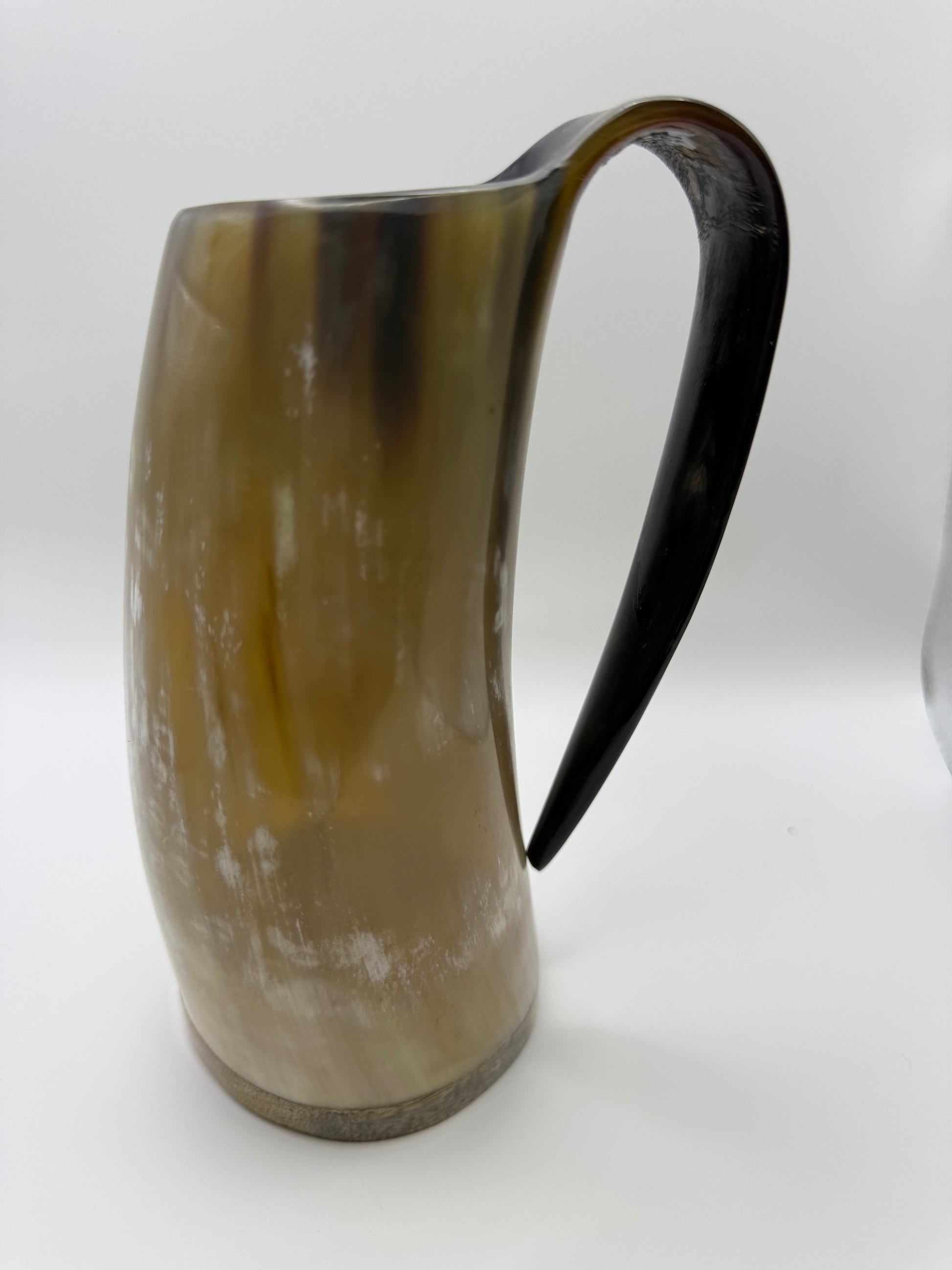 Horn-shaped mug with a black handle on a white background