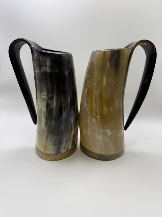 Two horn pitchers on a white background
